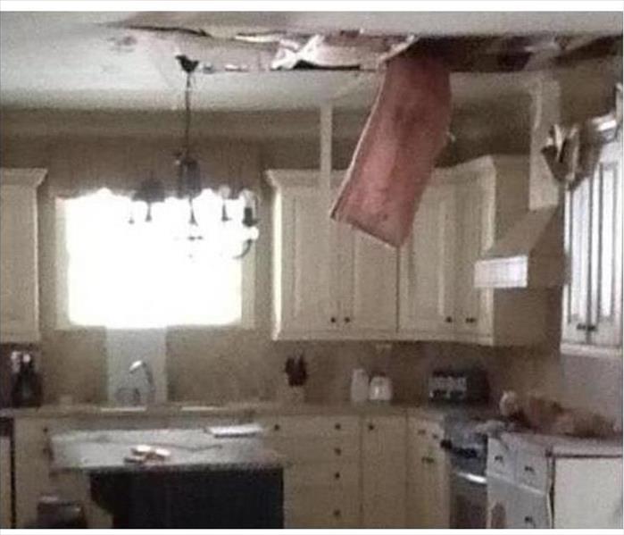 water damaged ceiling, hanging debris and batten insulation