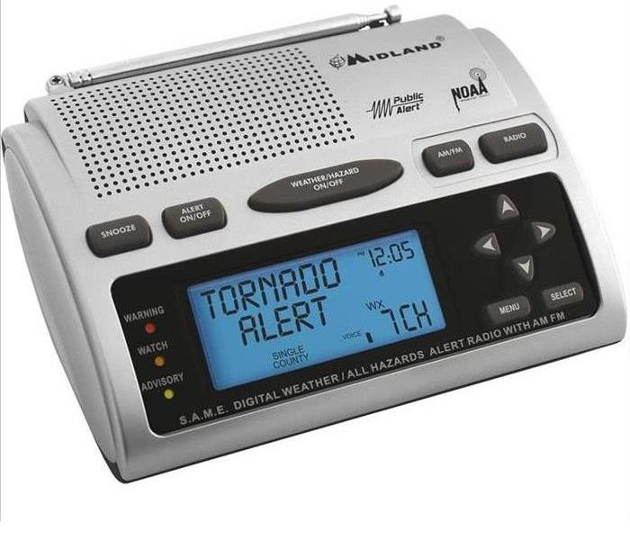 silver weather radio that says Tornado alert on the display