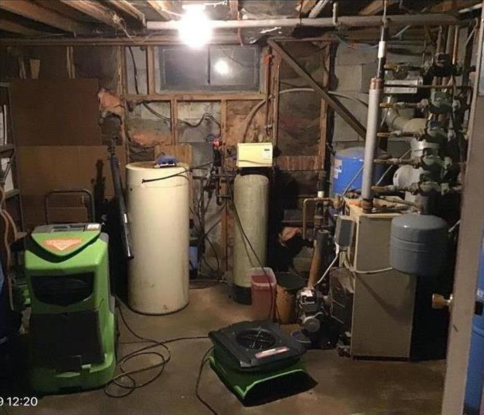 A broken supply line caused this Clinton basement to have water damage 