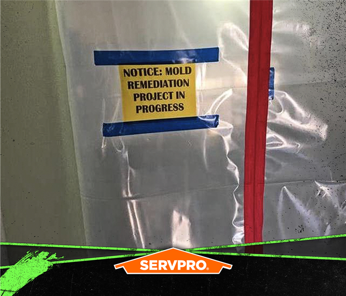 containment with poly sheeting and sign