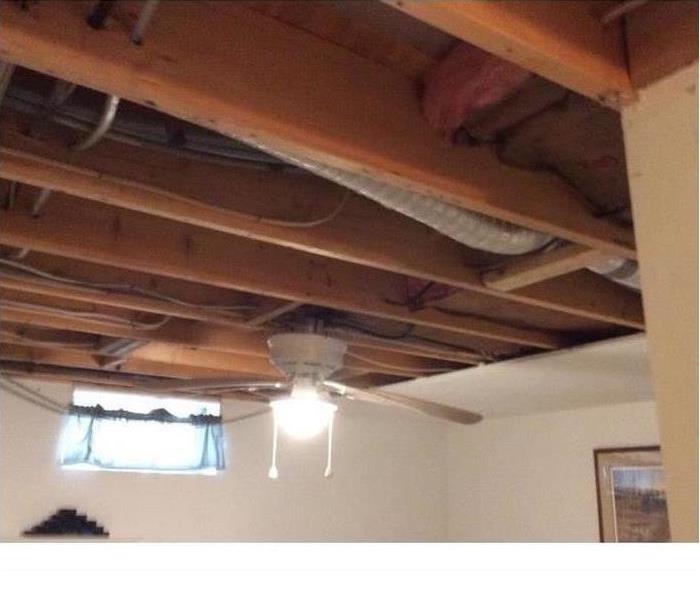 demolished ceiling, fan in bedroom